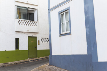 Fototapeta na wymiar colorful houses buildings in Lagos Portugal blue green doors windows 