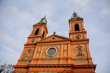 Fototapeta na wymiar Facade of the Church of Saint Wenceslas (Saint Vaclav) in Smichov district, three-aisled nave red basilica with two towers in neo-renaissance or pure style, Prague, Czech Republic