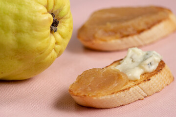 homemade quince jam. slices of bread with cheese and quince jam.