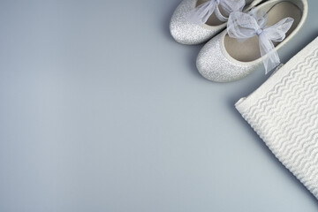 Folded jacket and shoes for children on a gray-blue background. Top view with space to copy. The concept of children's clothing.