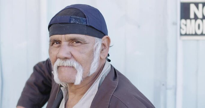 Portrait of serious older worker looking at camera