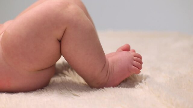 Caucasian baby girl laying on carpet