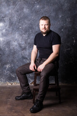 Solid bearded man dressed in t-shirt studio portrait