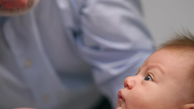 Grandfather talking to baby granddaughter