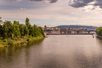 Obraz premium Panoramic view of picturesque Prague city on sunset. River Vltava and Prague bridges. Prague, Czech Republic