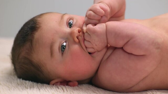 Caucasian baby girl laying on carpet