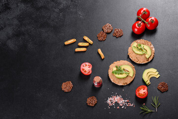Obraz na płótnie Canvas Tasty fresh sandwich with liver paste, avocado pieces and a arugula