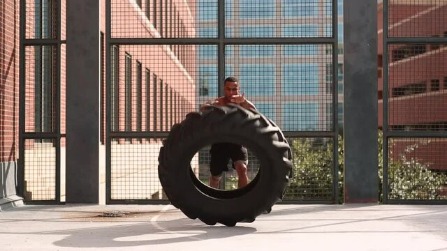 Athlete lifting tire on roof