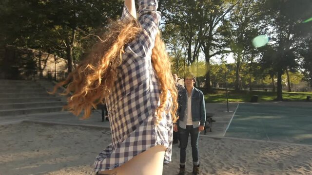 Friends swinging on playground rings, New York City, New York, United States