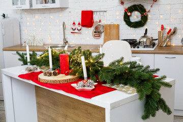 Green Christmas tree, decorated with balls, Christmas decorations, yellow garlands. New Year decorations in the kitchen. New Year. Decorations in the house for Christmas.