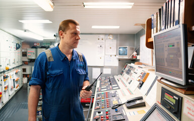 Marine Engineer working on radio communication at Engine Control room ECR. Vessel communication...
