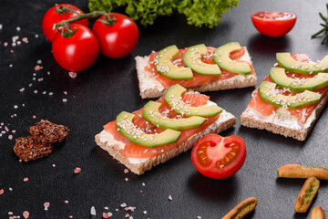Delicious fresh sandwich with red fish, butter, bread and avocado