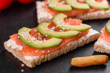 Delicious fresh sandwich with red fish, butter, bread and avocado