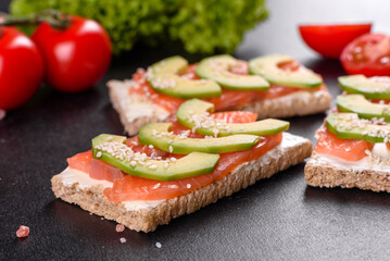 Delicious fresh sandwich with red fish, butter, bread and avocado