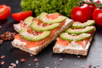 Delicious fresh sandwich with red fish, butter, bread and avocado