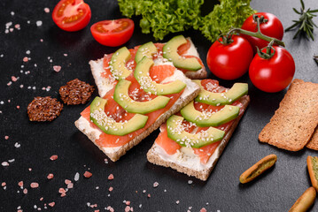Delicious fresh sandwich with red fish, butter, bread and avocado