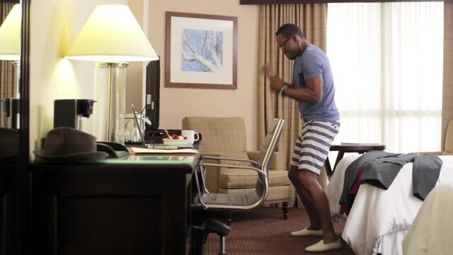 Black man boxing to television in hotel