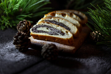 Poppy seed strudel on wooden rustic table. Traditional christmas strudel or Roll cake
