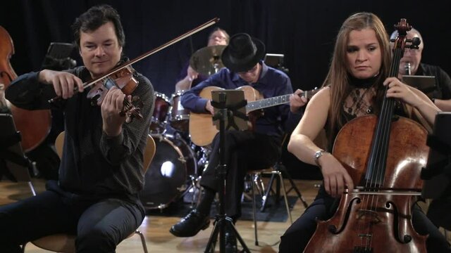 Band playing stringed instruments in studio space