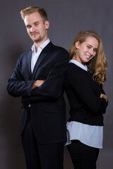 Young beautiful couple studio portrait on grey background.