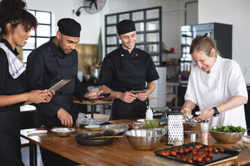 Female chef and divserse group in kitchen
