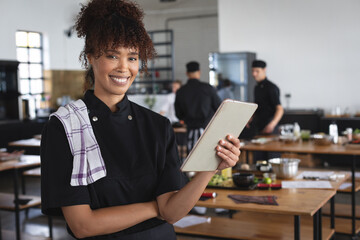 Mixed race female chef in kitchen