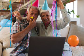 Senior caucasian couple on video call celebrating birthday