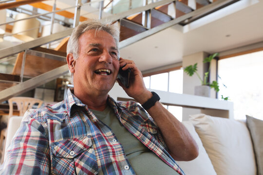 Smiling senior caucasian man having phone call on smartphone