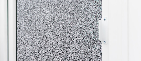 The outer metal handle of the new plastic door is white