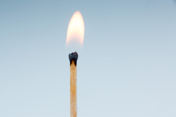 burning match on a light background close-up