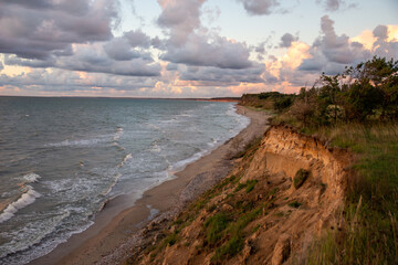 Cumulus clouds in sunset near the cliffs
