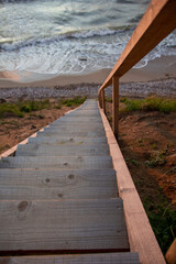 Long wooden stairs going in the sea