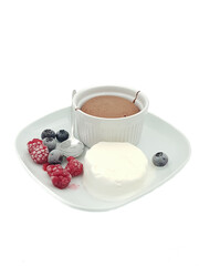 Chocolate fondant with berries served on a white plate