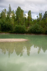 Blue clear water lake with wood reflection