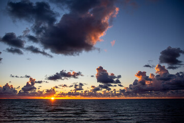 Cumulus clouds over the sea in the sunset