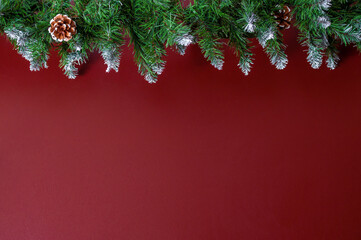 Obraz na płótnie Canvas Christmas garland on a red wall background