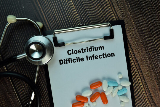 Clostridium Difficile Infection write on sticky notes isolated on Wooden Table. Medical or Healthcare concept