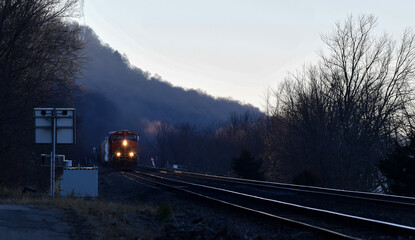 Freight train locomotive moving along the countryside
