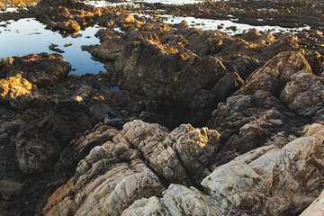 Praia do Coral sunset Viana do Castelo Portugal shore coast beach rocks waves water rocks close up 
