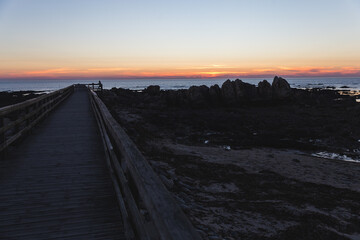 Praia do Coral sunset Viana do Castelo Portugal shore coast beach rocks sand footbridge pathway