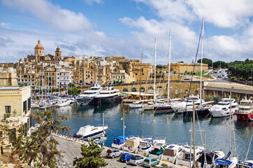Fototapeta na wymiar A lot of boats and yachts in the port of La Valletta, Malta