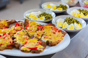 Served tasty meal on a plate in restaurant close up view.