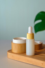 Natural cosmetic product set. Jar of organic moisturizer cream and body lotion in dropper bottle. SPA beauty products. Skincare concept.