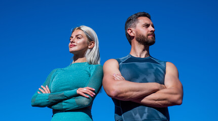 confident sport couple. muscular man and sexy woman in sportswear. athlete people feel success. fitness trainer and coach. guy and woman relax after workout outdoor. sporty fashion