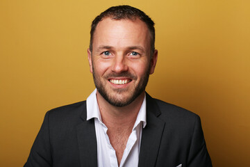 Portrait of a man in front of a colored background