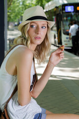 smoking female waiting for a bus