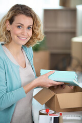 excited young woman holding cardboard box