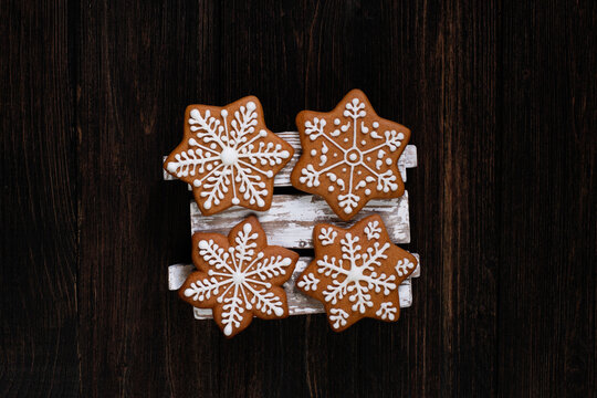 Various christmas gingerbread stars on wooden background