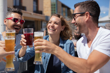 friends having fun and drinking a cold beer