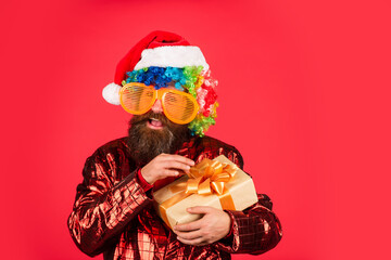 Cool Specials. Christmas entertainment ideas. Wishing you peace and prosperity. Christmas gift. Cheerful guy colorful hairstyle. Funny man with beard. Winter holidays. Bearded man celebrate christmas